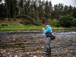 Angler playing an atlantic salmon river Dee, Scotland with Twinpeakesflyfishing